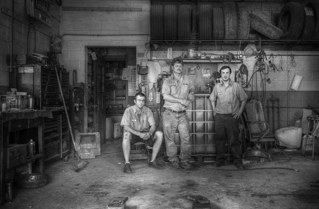 black and white photo of three auto mechanics