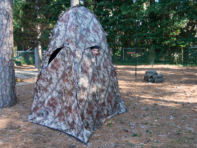 camouflage bird blind with person looking out